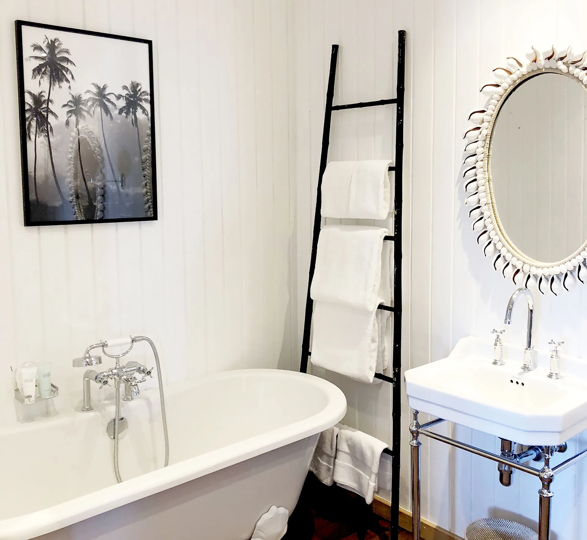 Havana Suite bathroom with freestanding tub and shell-framed mirror at GYP SEA Saint Barth.