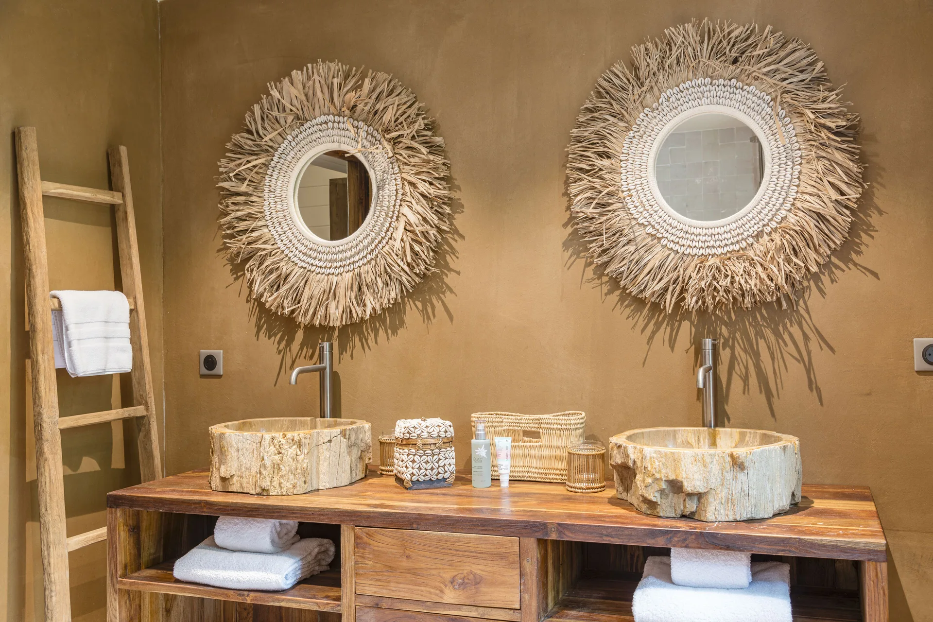 Double vanity with round mirrors and stone basins at GYP SEA Saint Barth.