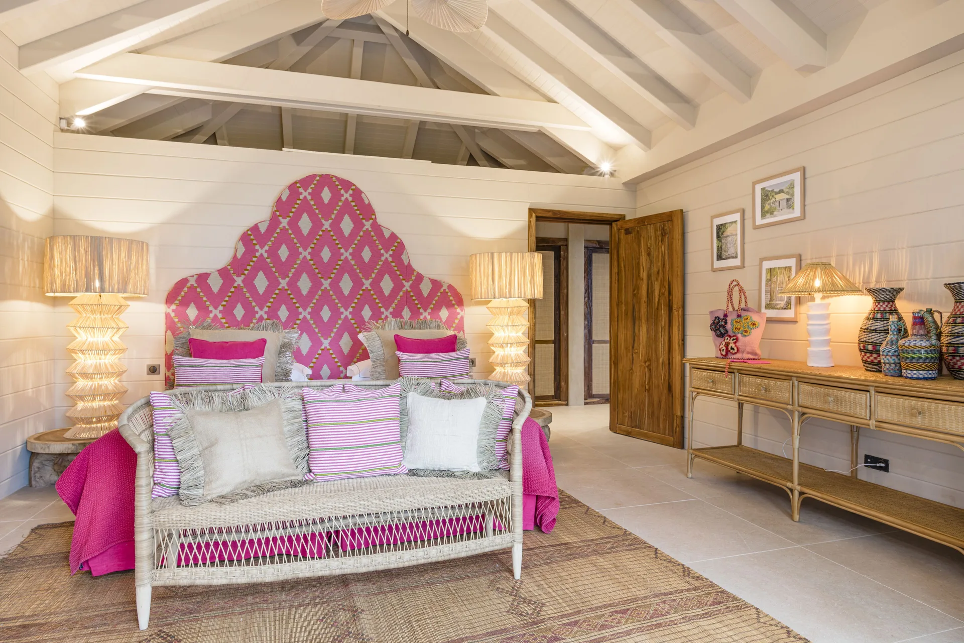 Pink-accented bedroom with king bed at GYP SEA Saint Barth.