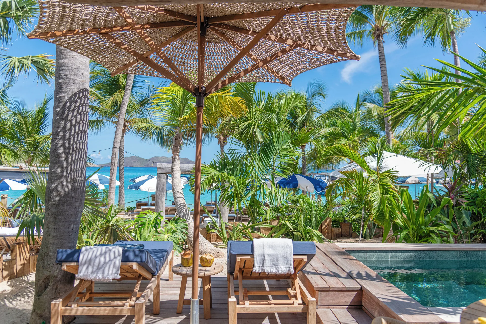 Private terrace with pool, loungers, palms, and sea view at GYP SEA Saint Barth.