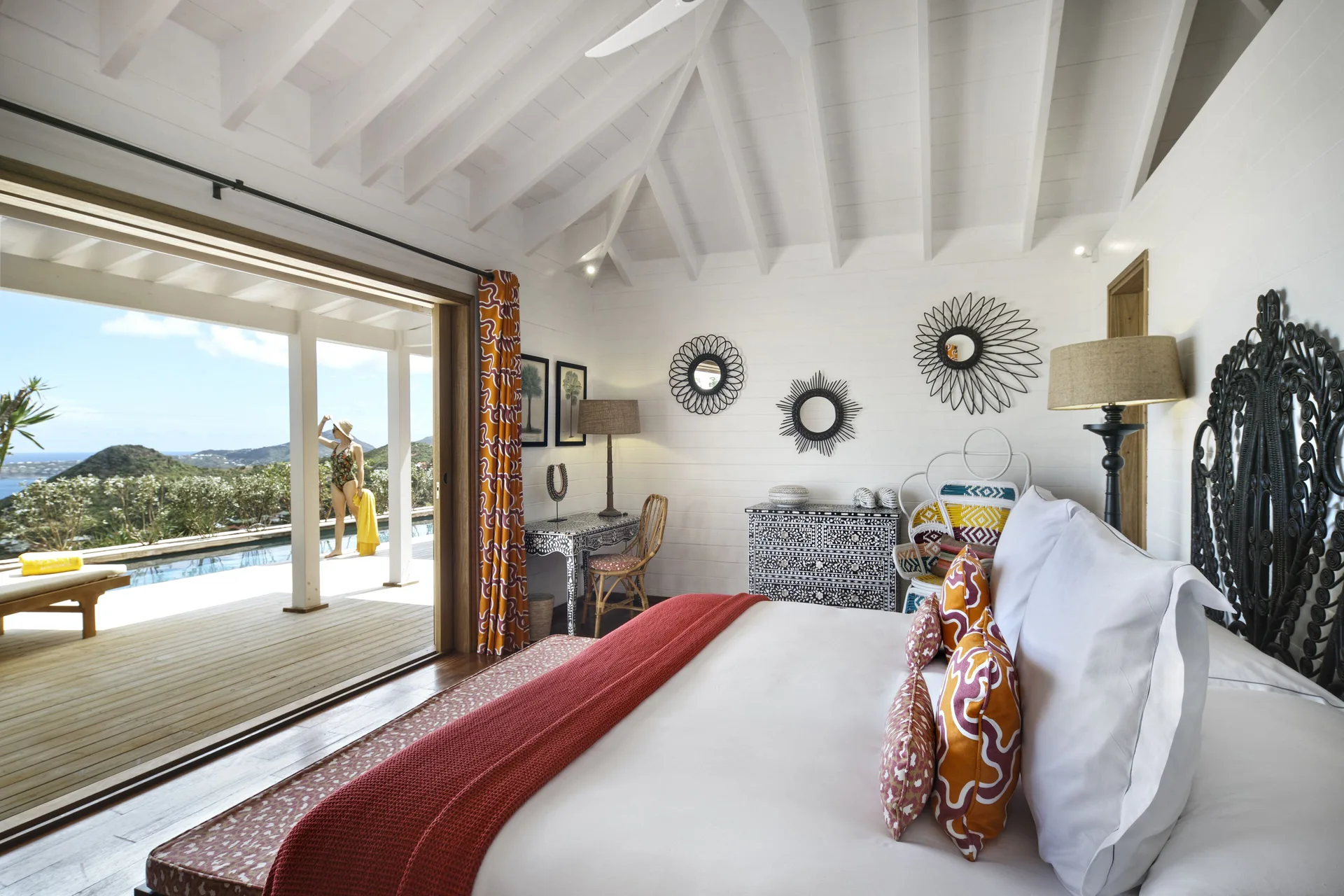 Villa bedroom with king bed opening to a pool terrace at GYP SEA Saint Barth.