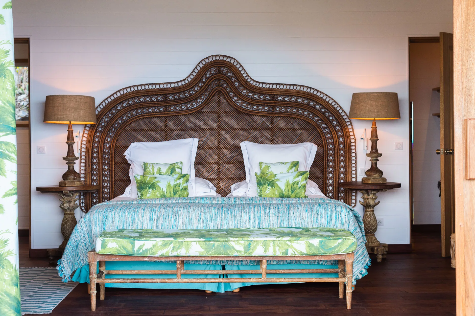 Villa bedroom with king bed and woven headboard at GYP SEA Saint Barth.