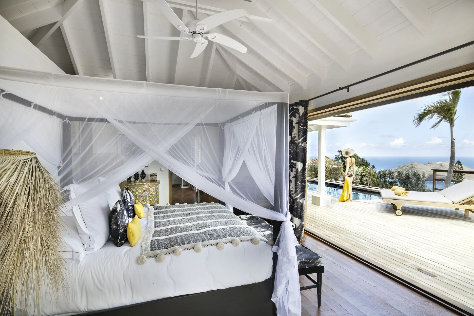 Villa master bedroom with canopy king bed and pool terrace at GYP SEA Saint Barth.