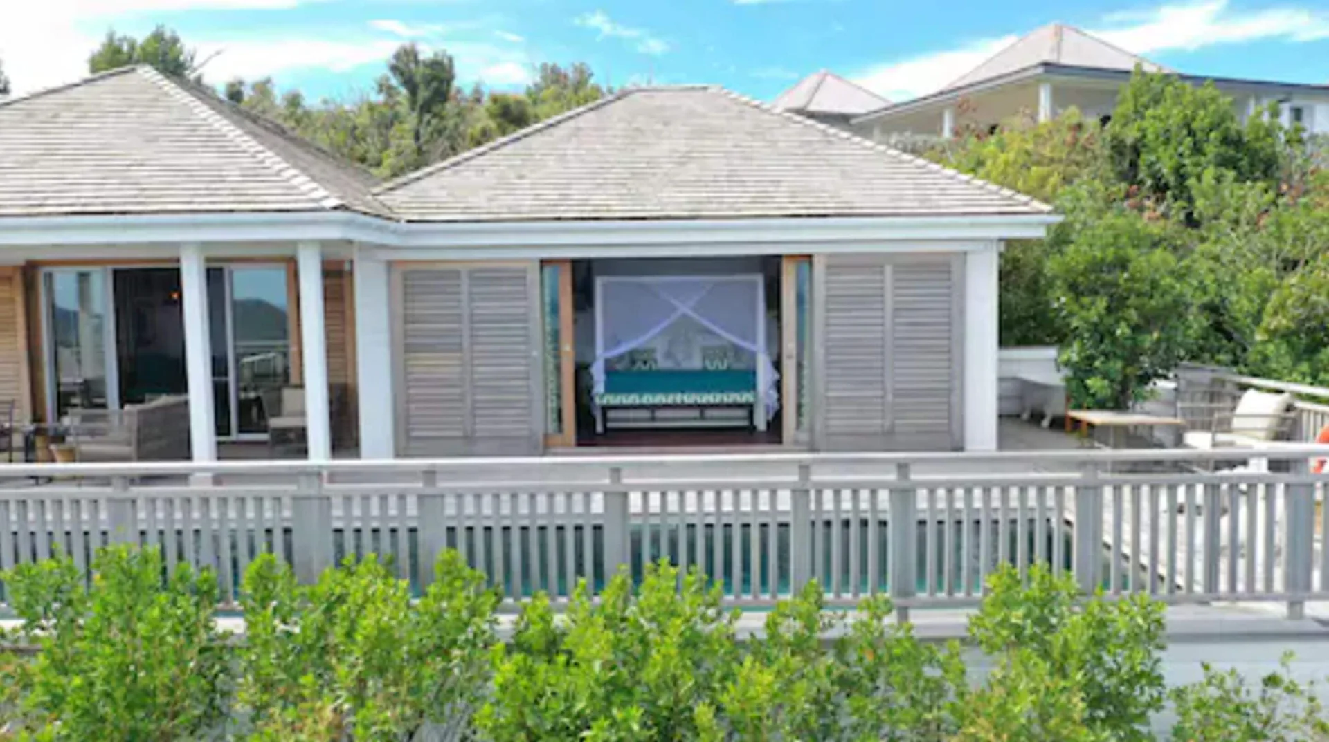 Villa bedroom opening to the pool terrace at GYP SEA Saint Barth.