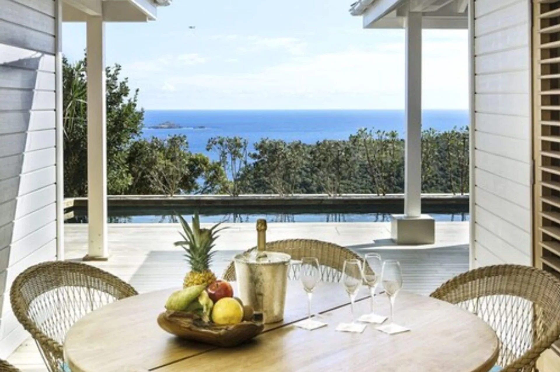 Villa terrace dining table by a pool with sea view at GYP SEA Saint Barth.