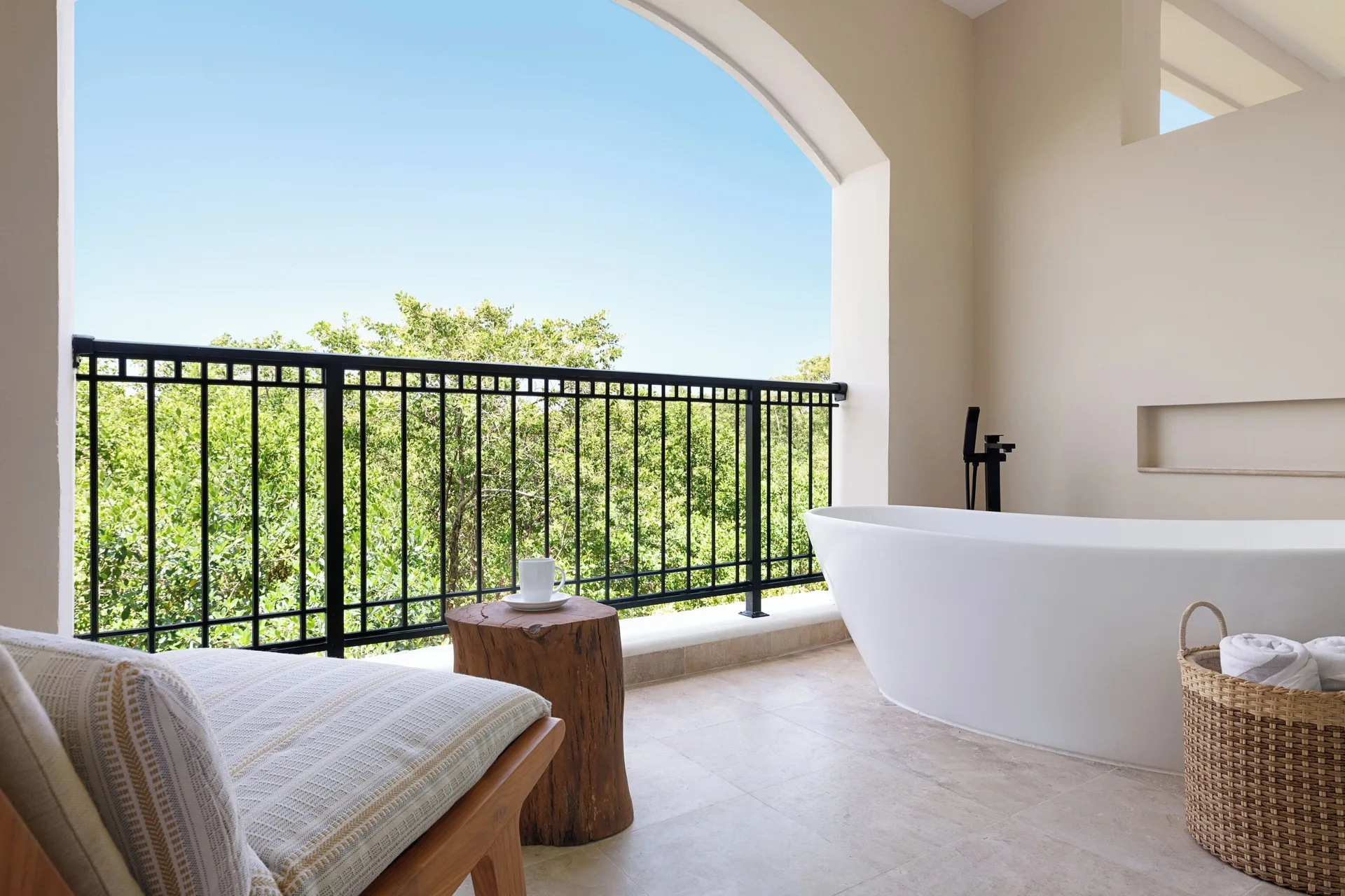 Balcony soaking tub with treetop view at Hacienda Tres Rios Resort, Spa & Nature Park.