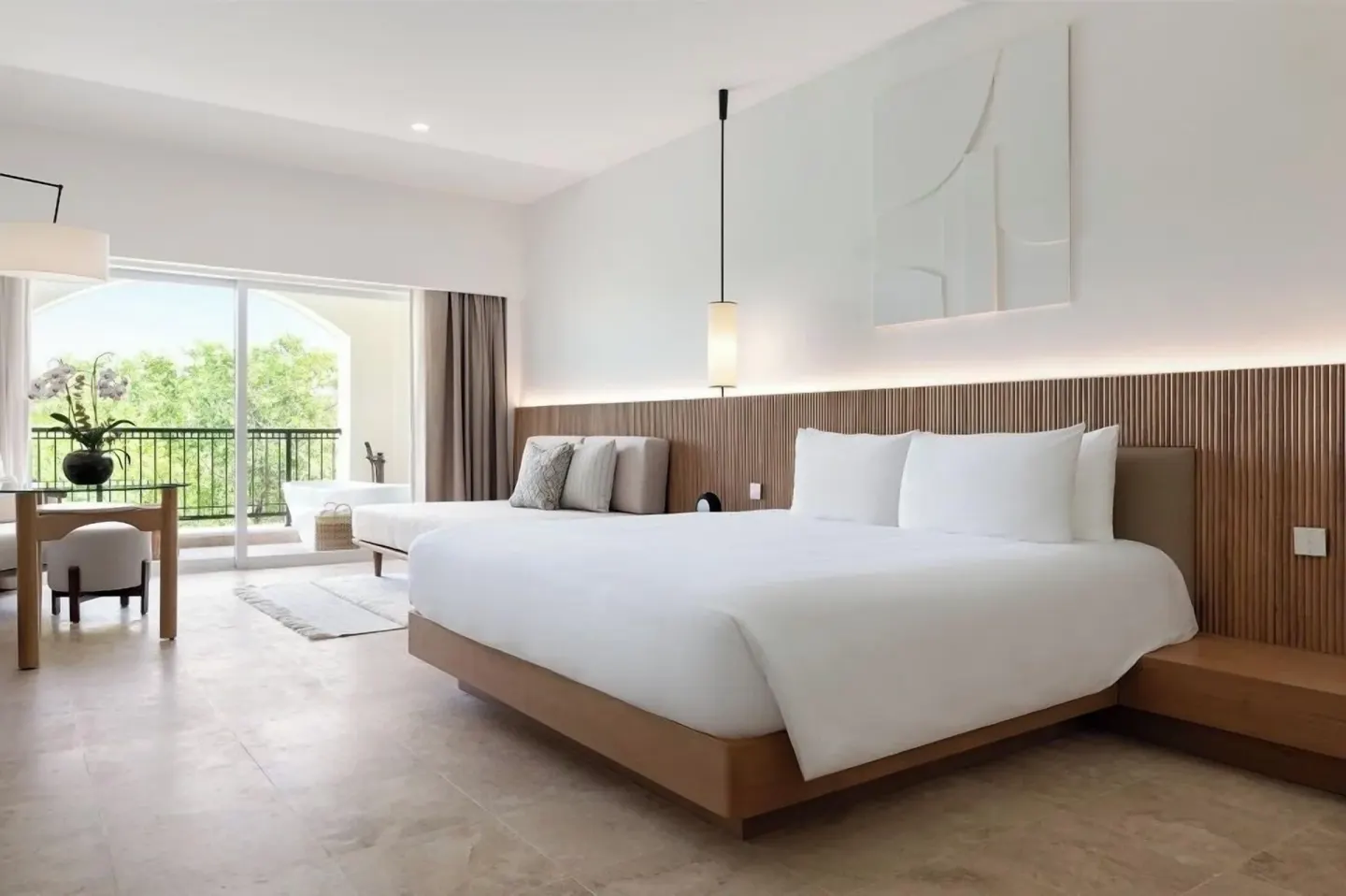 King bed guest room with sitting area at Hacienda Tres Rios Resort, Spa & Nature Park.
