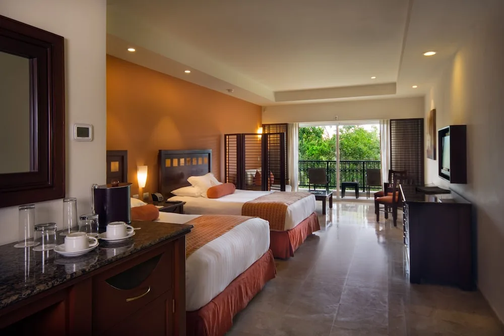 Guest room with two double beds and balcony at Hacienda Tres Rios Resort, Spa & Nature Park.