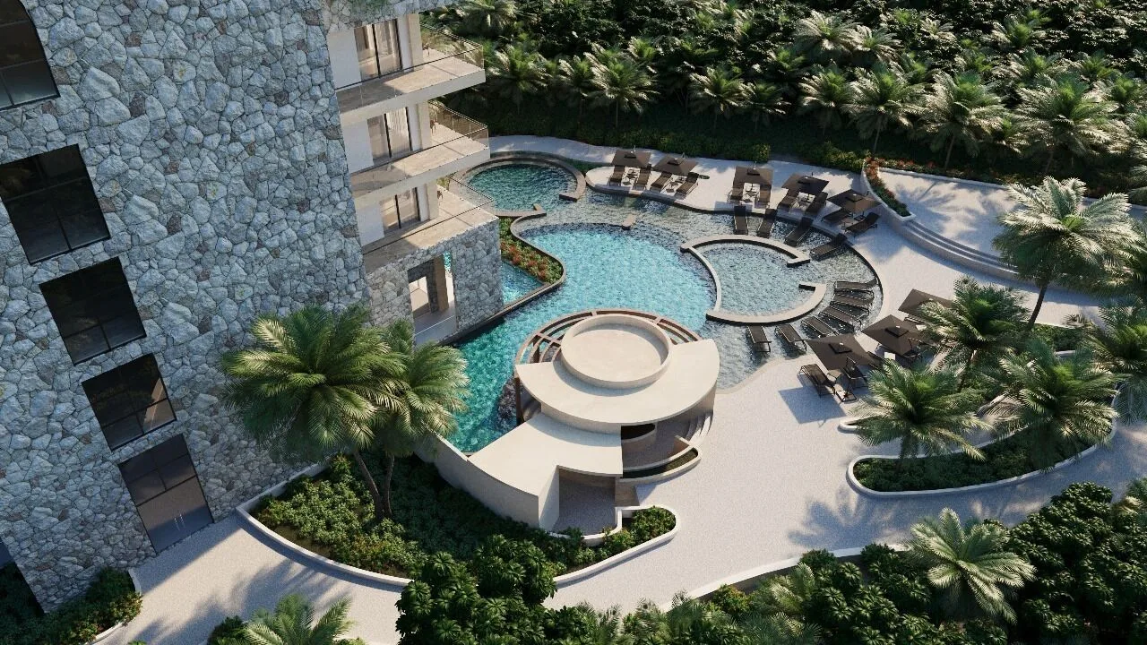 Resort pool complex among palm trees at Hacienda Tres Rios Resort, Spa & Nature Park.