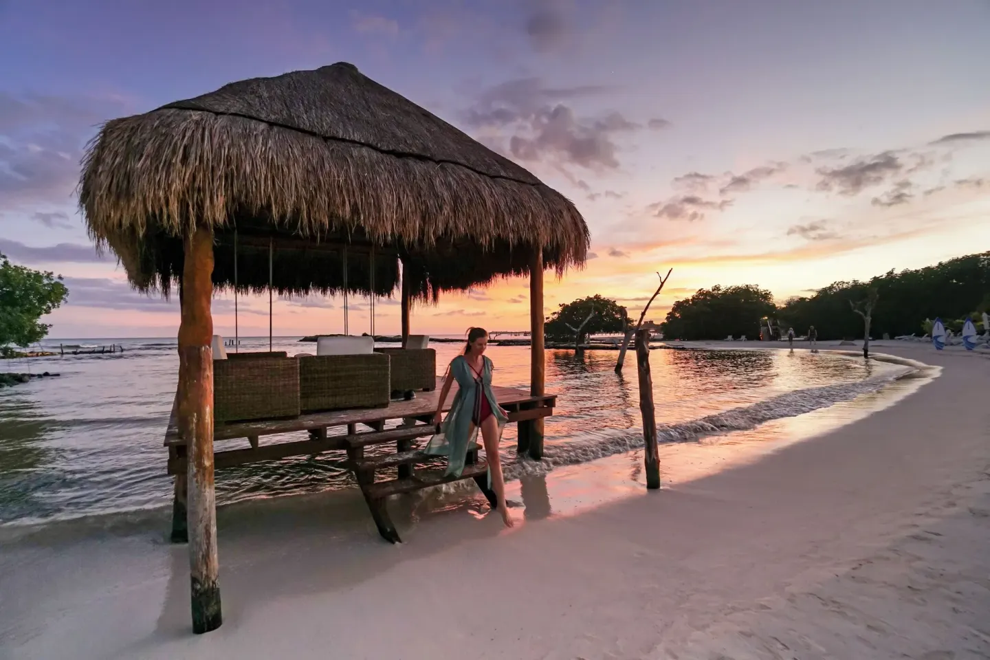 Thatched beach palapa at sunset at Hacienda Tres Rios Resort, Spa & Nature Park.