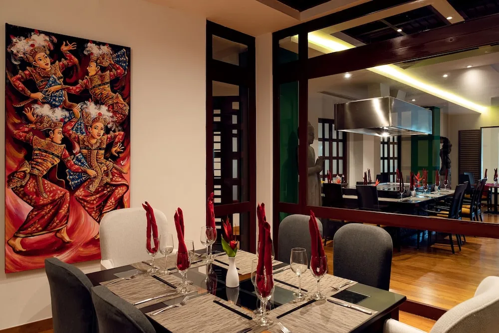 Set dining tables and colorful wall art at Hacienda Tres Rios Resort, Spa & Nature Park.