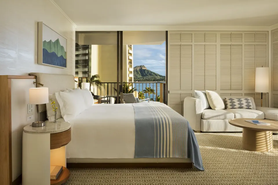Ocean-view guest room with king bed and Diamond Head visible at Halekulani.