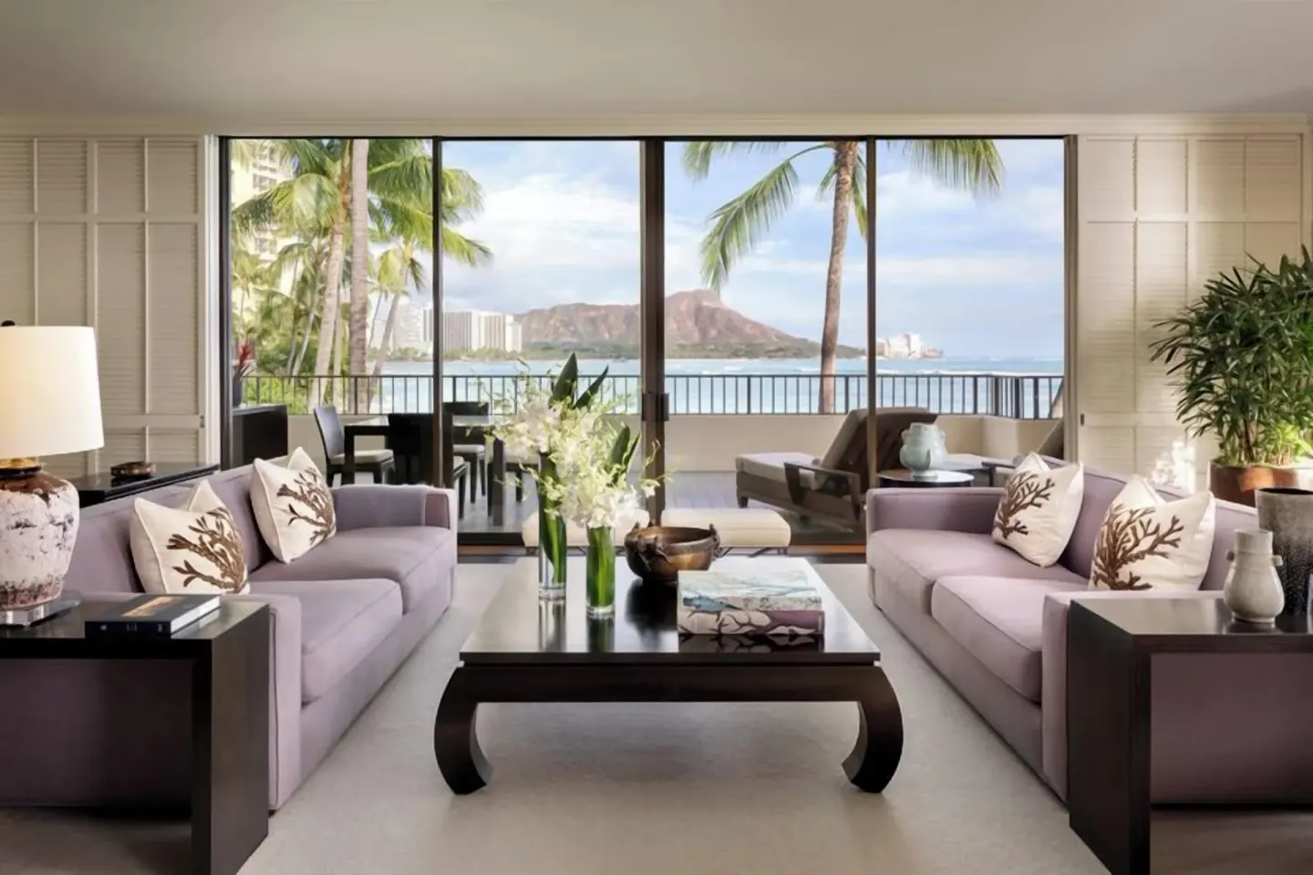 Suite living room with sofas, lanai, ocean, and Diamond Head views at Halekulani.