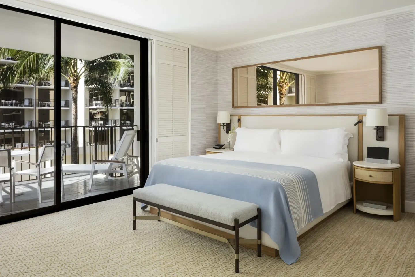 Garden courtyard guest room with king bed and balcony at Halekulani.