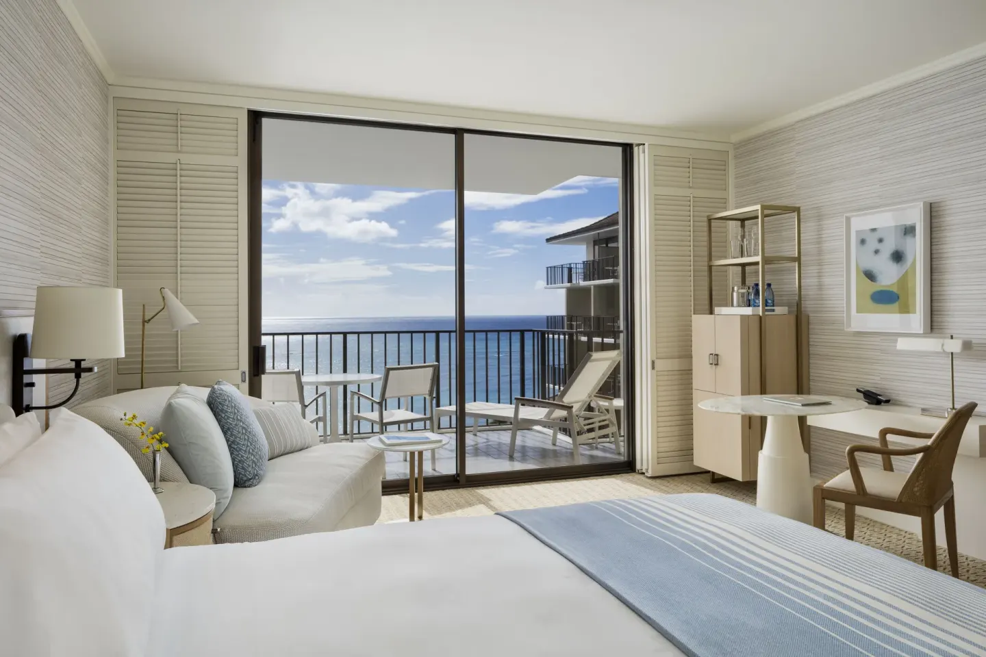 Oceanfront guest room with bed, sofa, balcony, and ocean view at Halekulani.
