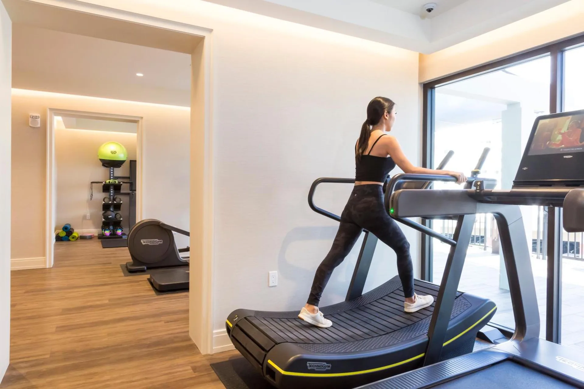 Fitness room with treadmill and exercise equipment at Halepuna Waikiki by Halekulani.