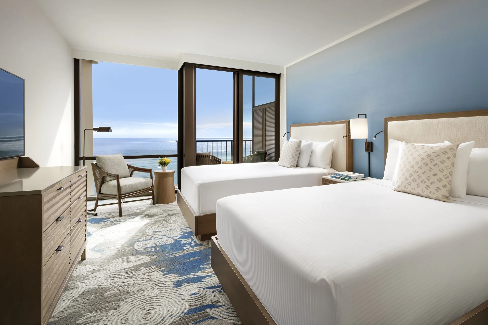 Ocean View room with two beds, seating, TV, and balcony at Halepuna Waikiki by Halekulani.