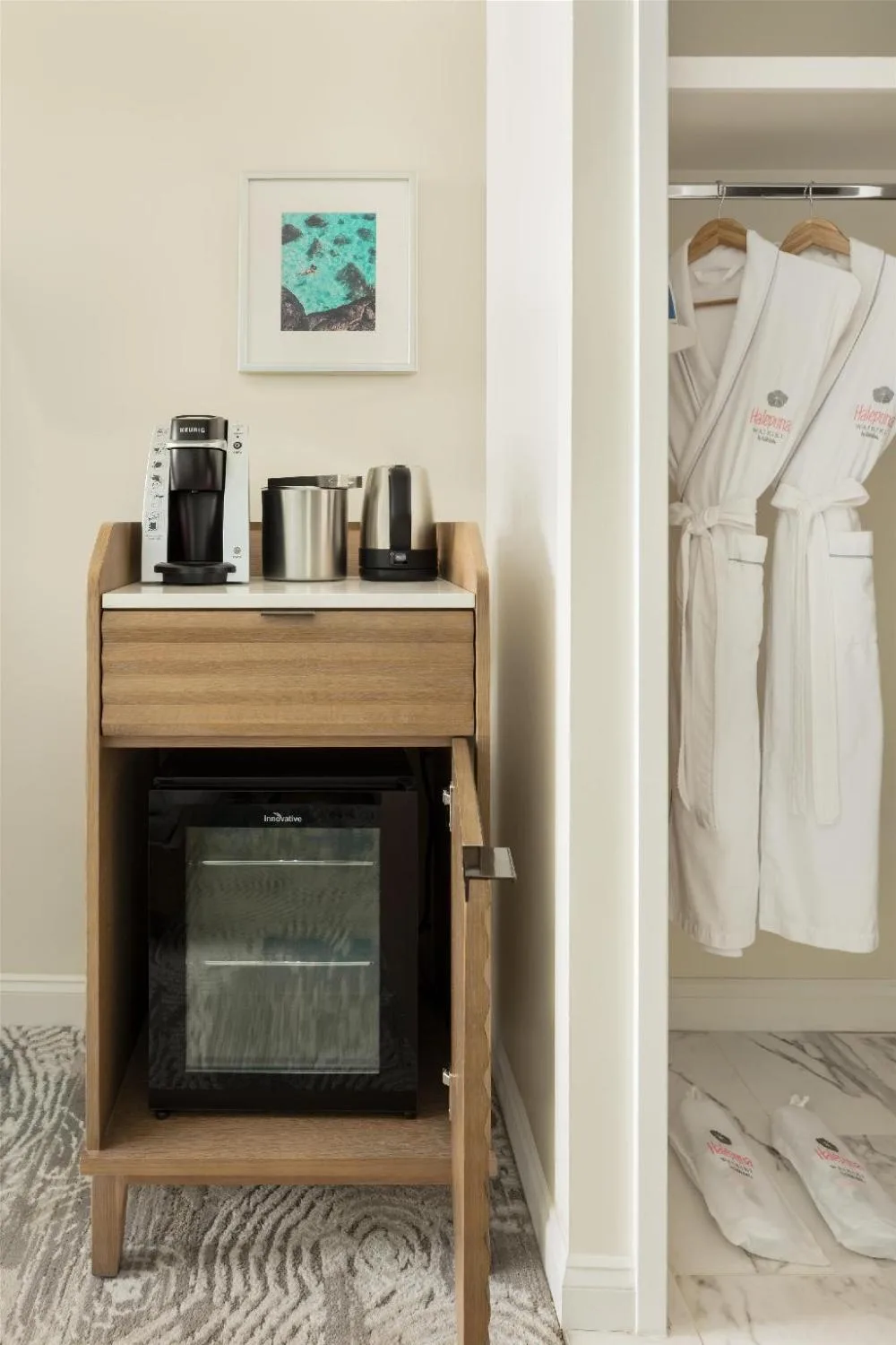 In-room beverage station, mini refrigerator, robes, and slippers at Halepuna Waikiki by Halekulani.