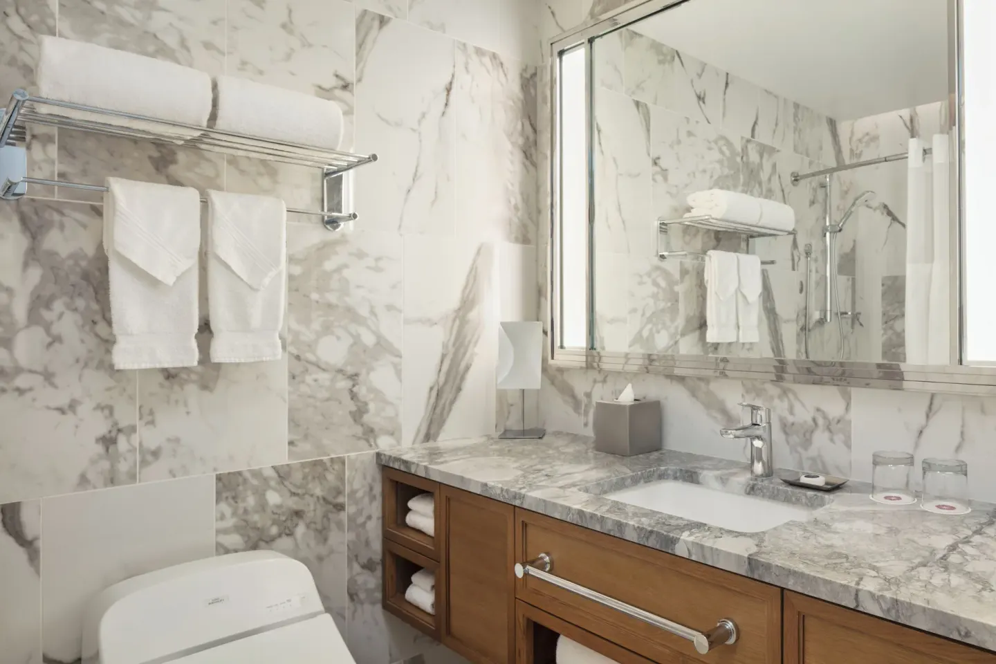 Standard Waikiki View bathroom vanity and marble walls at Halepuna Waikiki by Halekulani.