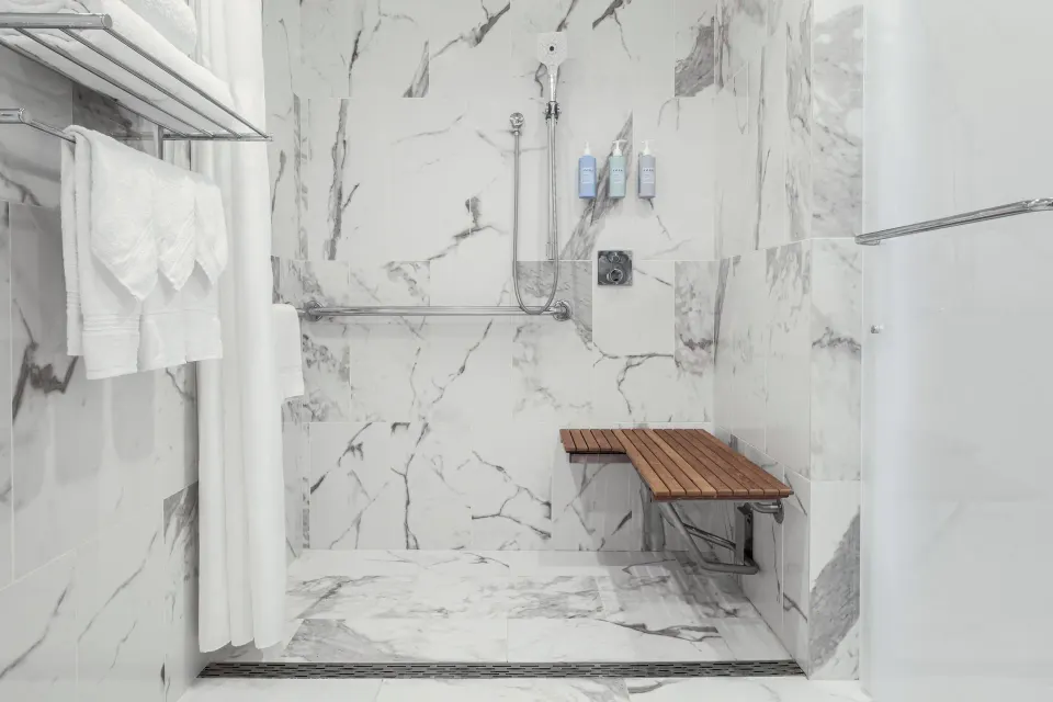 Standard Waikiki View marble shower with bench at Halepuna Waikiki by Halekulani.