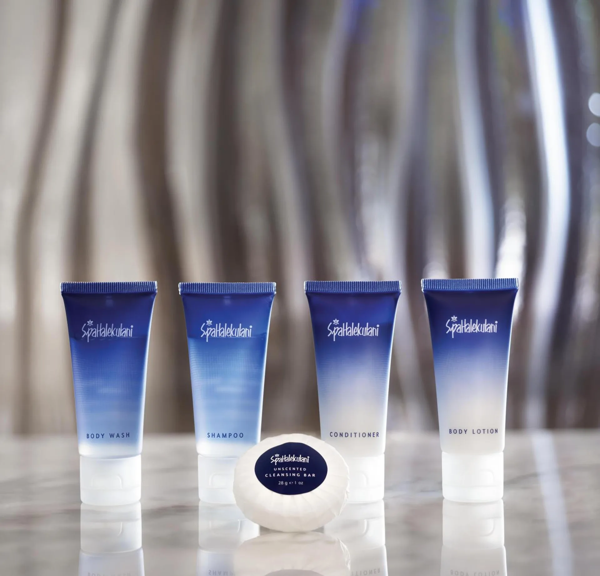 Bath amenities arranged on a counter at Halepuna Waikiki by Halekulani.