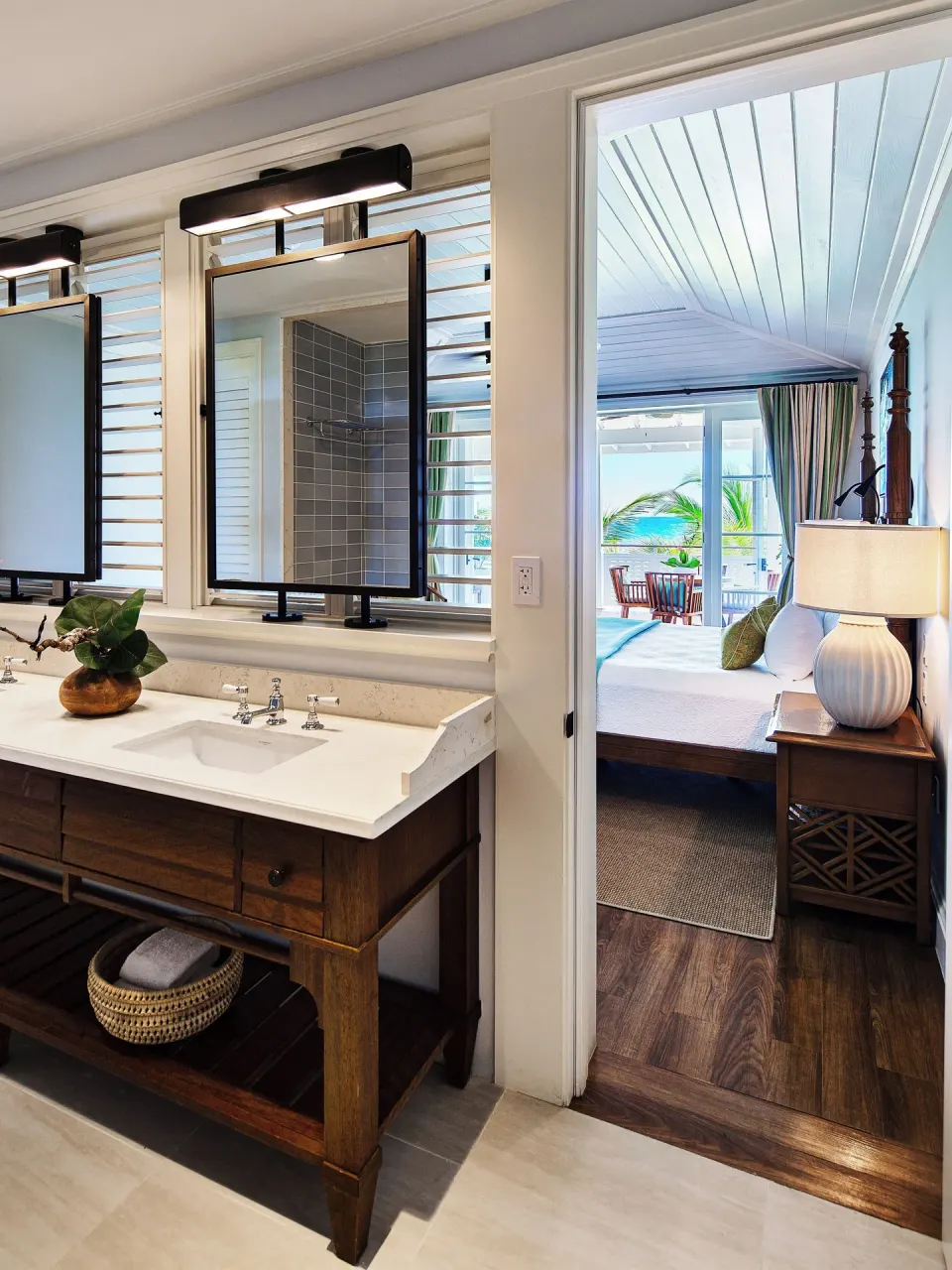 Bathroom vanity beside a bedroom with ocean-view balcony at Half Moon.