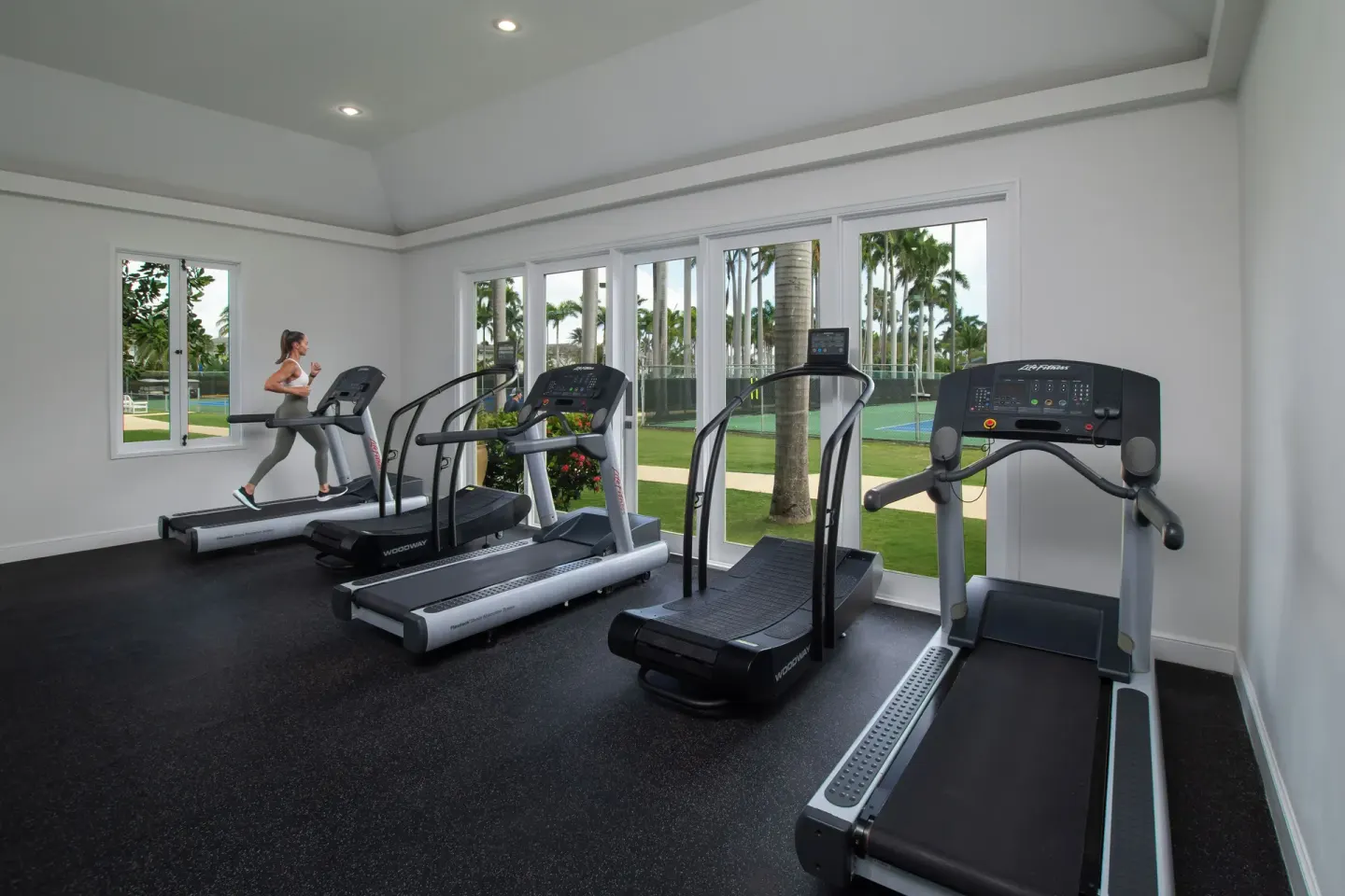 Treadmills face garden windows in the fitness center at Half Moon.