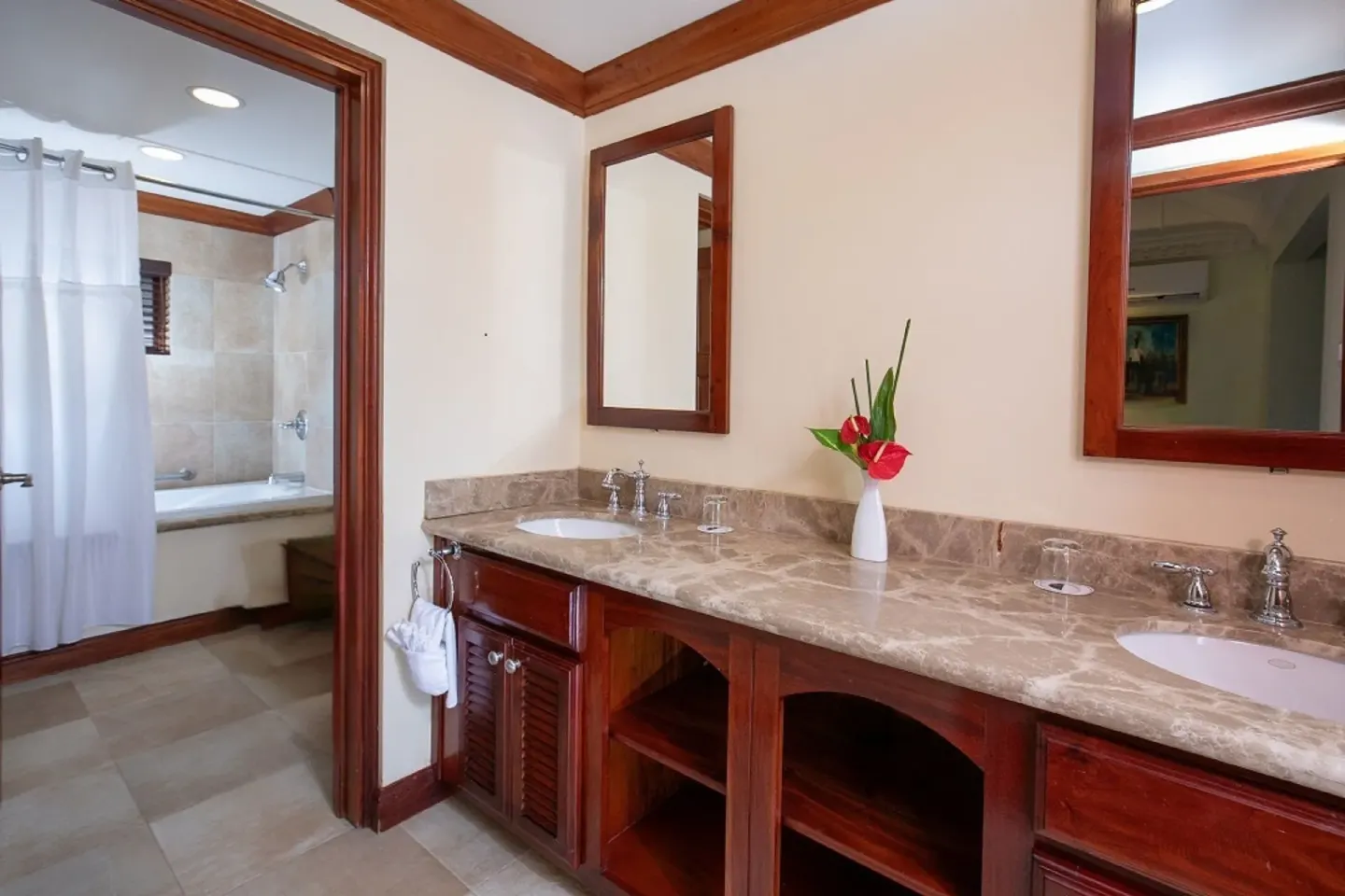 Double-sink bathroom vanity with marble counter and tub area at Half Moon.