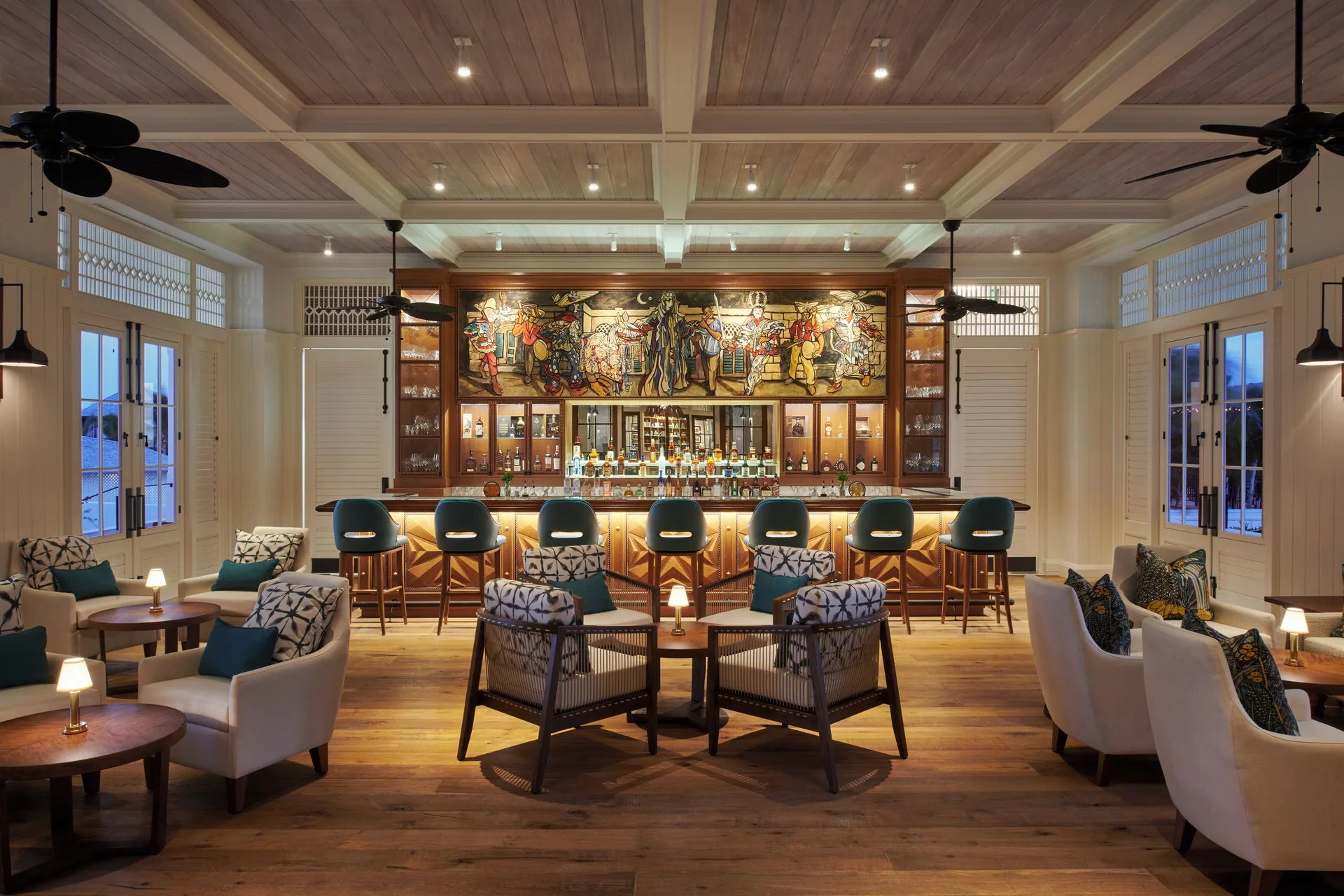 Elegant bar lounge with mural, seating, and high stools at Half Moon.