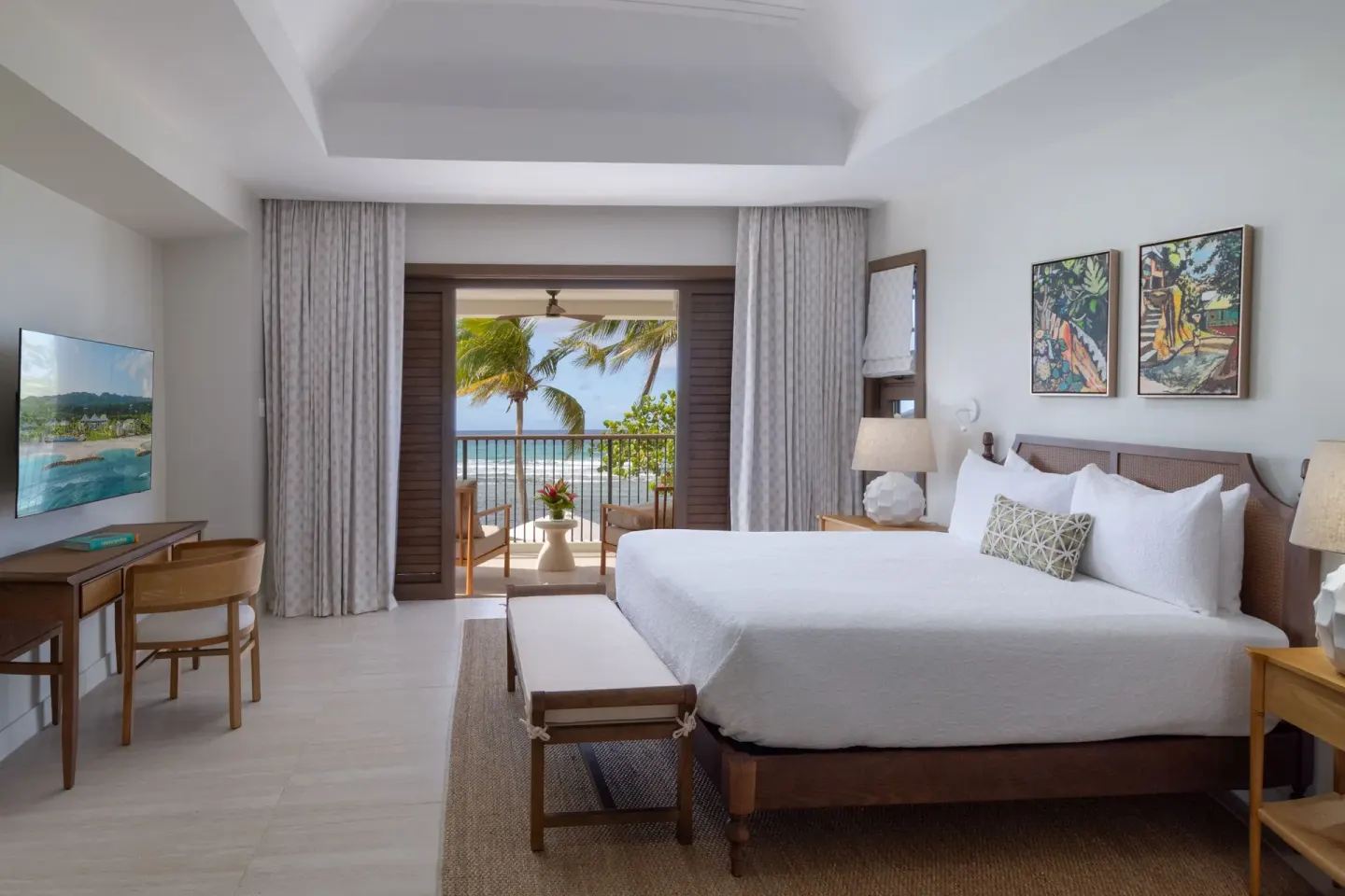 King bedroom in a 5 Bedroom Garden View Villa at Half Moon opening to a balcony with ocean beyond.
