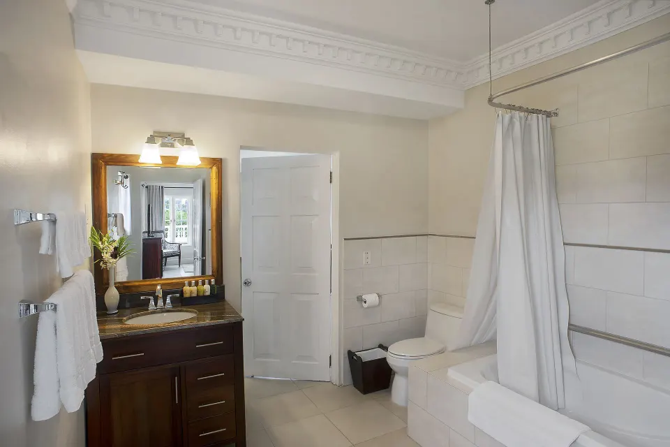 Bathroom vanity and curtained tub in a 5 Bedroom Ocean View Villa at Half Moon.