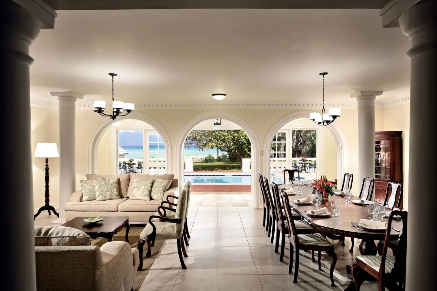 Ocean-view villa dining and sitting area opening to the pool at Half Moon.