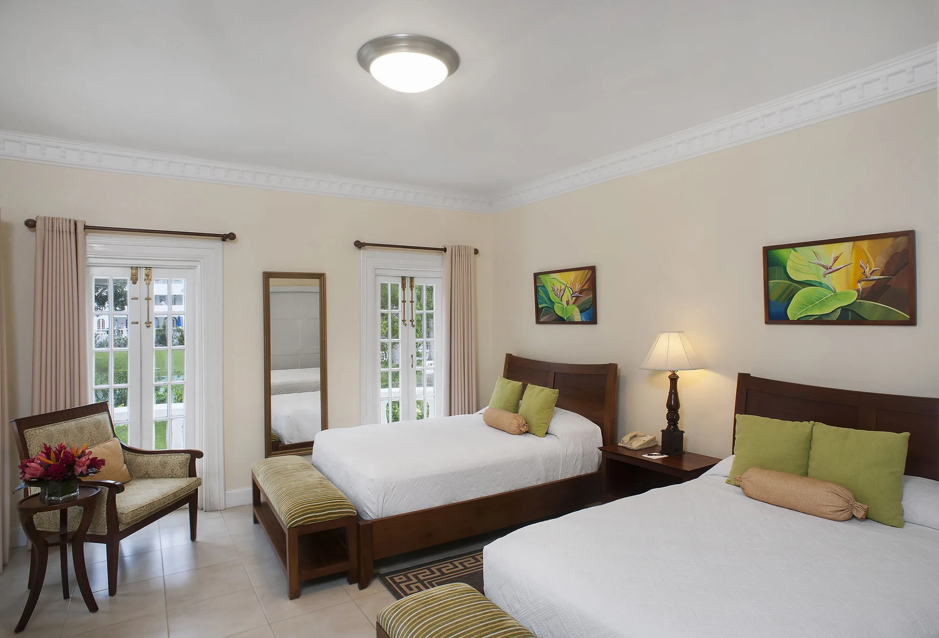 Twin-bed garden-view villa bedroom with French doors at Half Moon.
