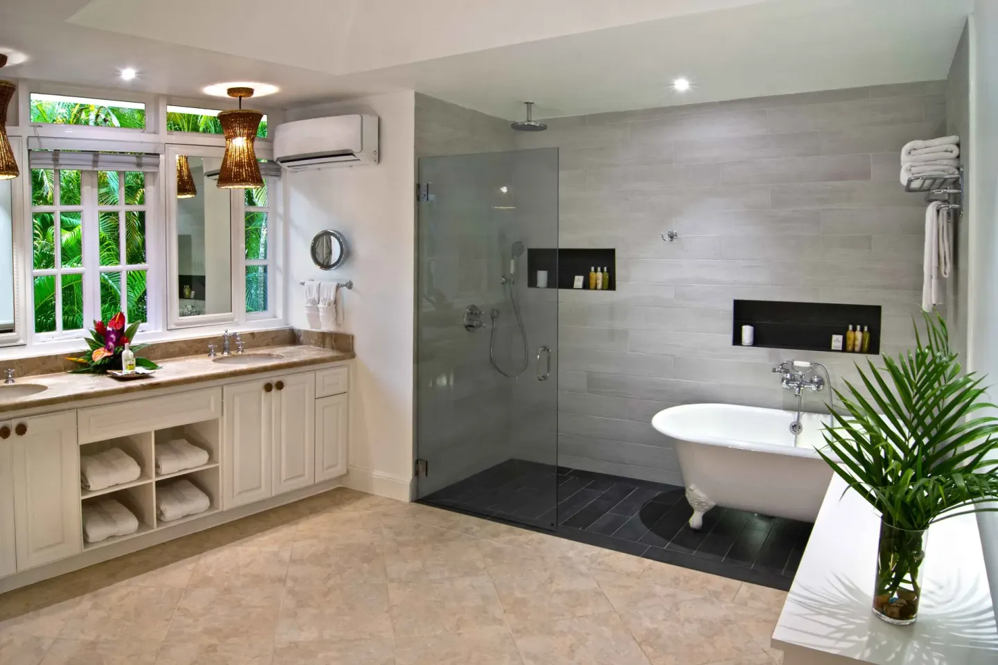 Junior Suite Ocean bathroom with double vanity, glass shower, and tub at Half Moon.