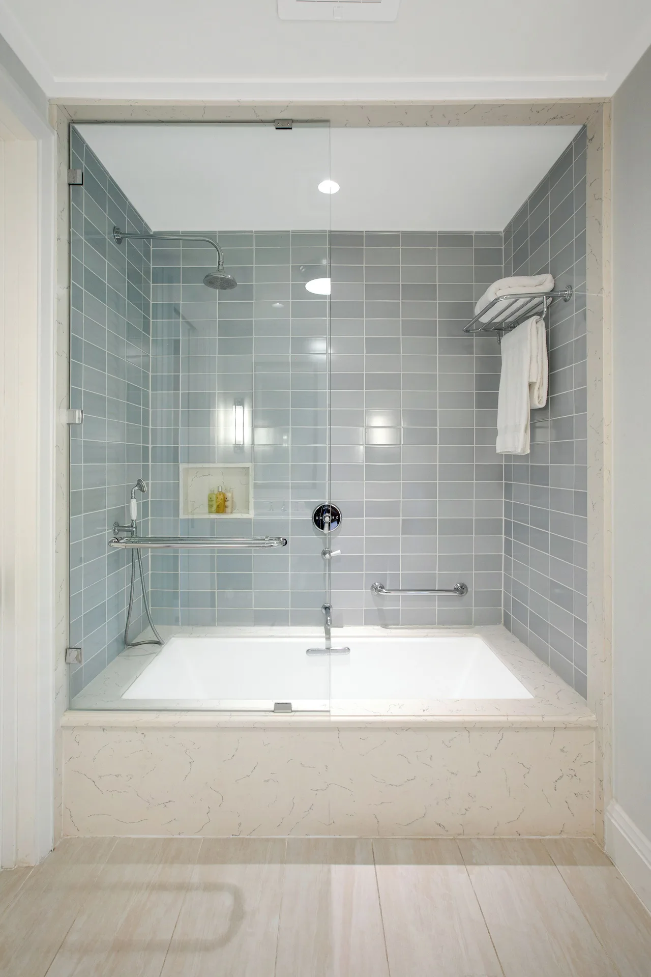 Guest room bathroom with glass shower and soaking tub at Half Moon.