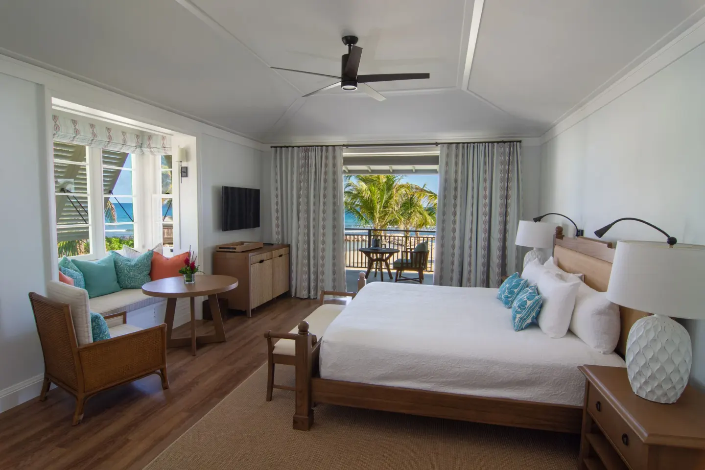 Ocean guest room with king bed, sitting area, and balcony at Half Moon.