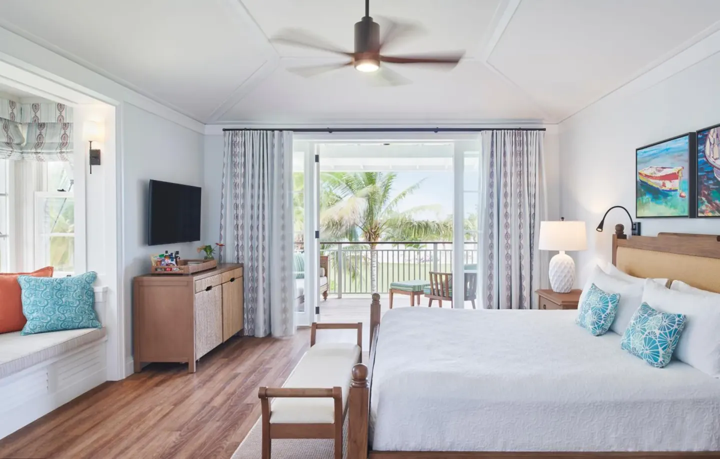 Estate Ocean guest room with king bed, window seat, and balcony at Half Moon.