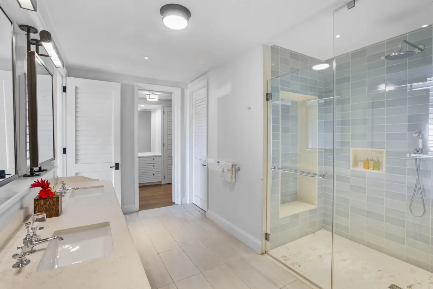 Great House Ocean bathroom with walk-in glass shower and double vanity at Half Moon.