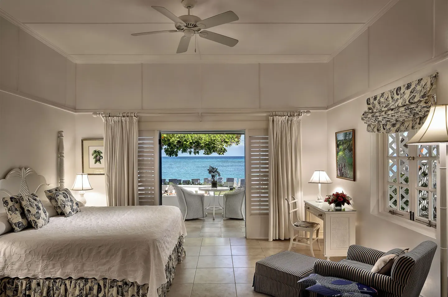 Ocean View room with king bed, sitting area, and open patio doors at Half Moon.