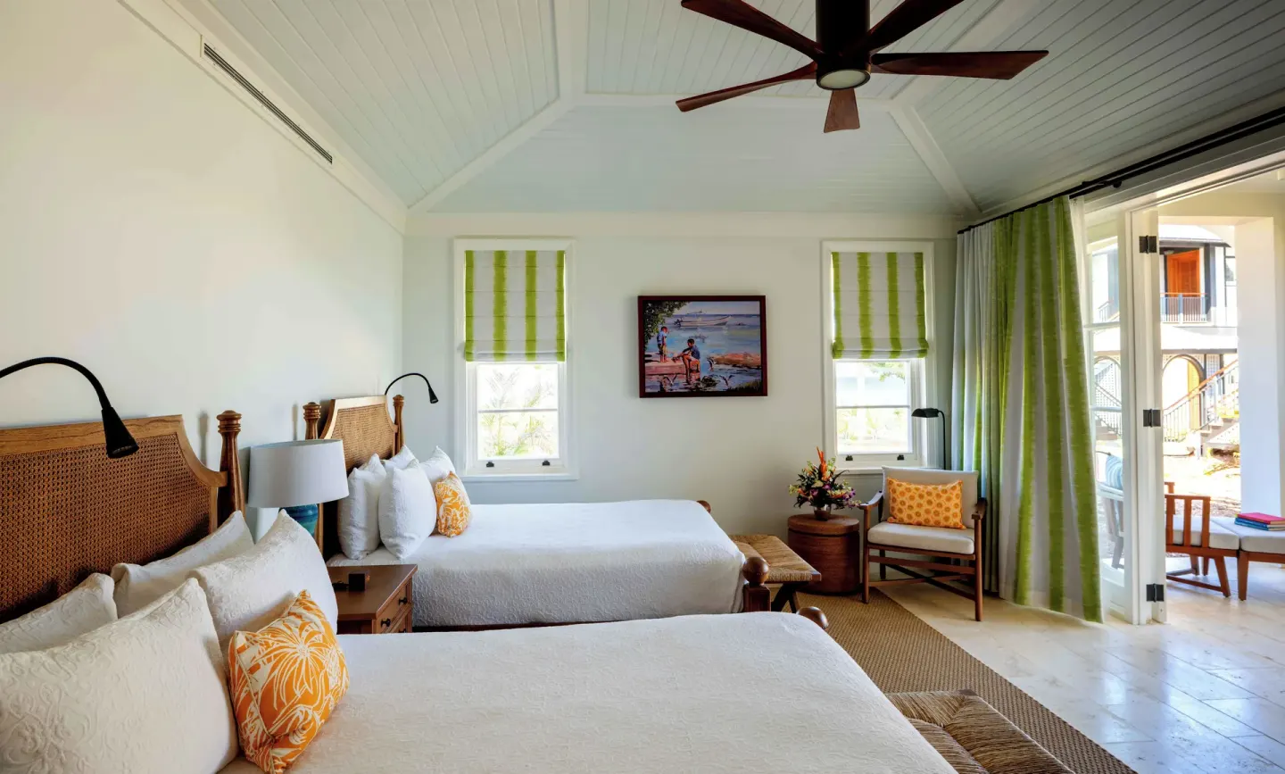 Ocean View room with two beds, green accents, and balcony doors at Half Moon.
