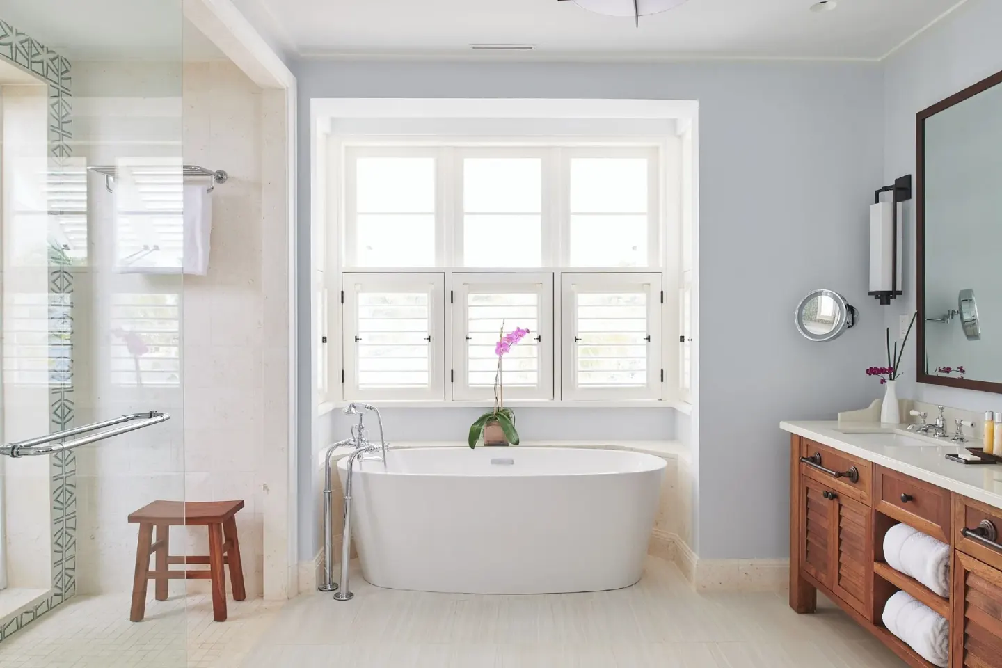 Ocean Estate Suite bathroom with soaking tub, shower and wood vanity at Half Moon.