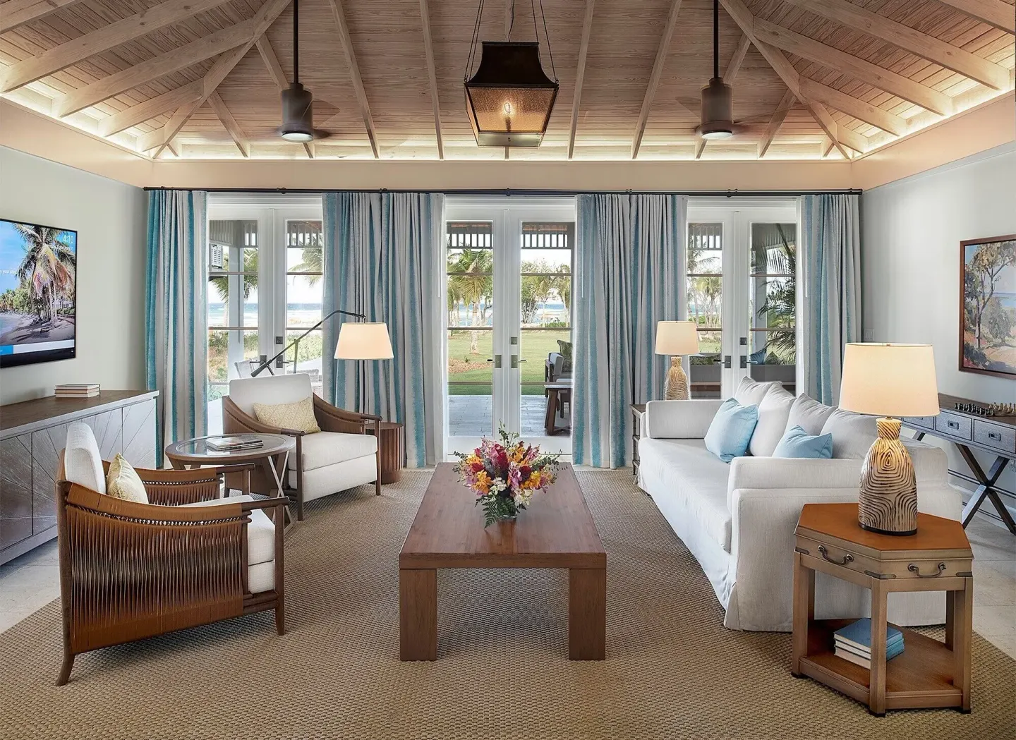 Ocean Estate Suite living room with sofa, armchairs and terrace doors at Half Moon.