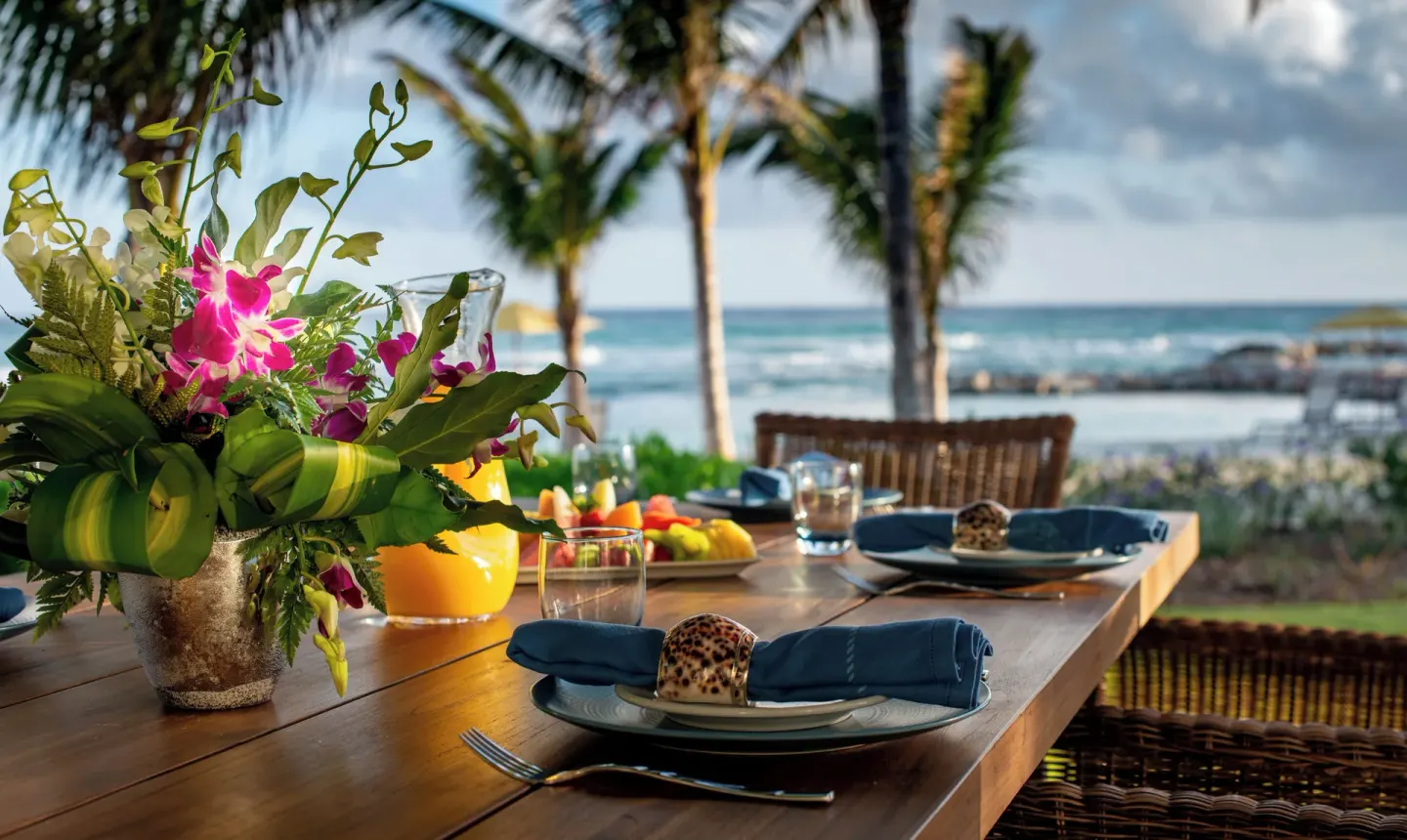 Ocean Estate Suite terrace dining table with flowers and sea view at Half Moon.