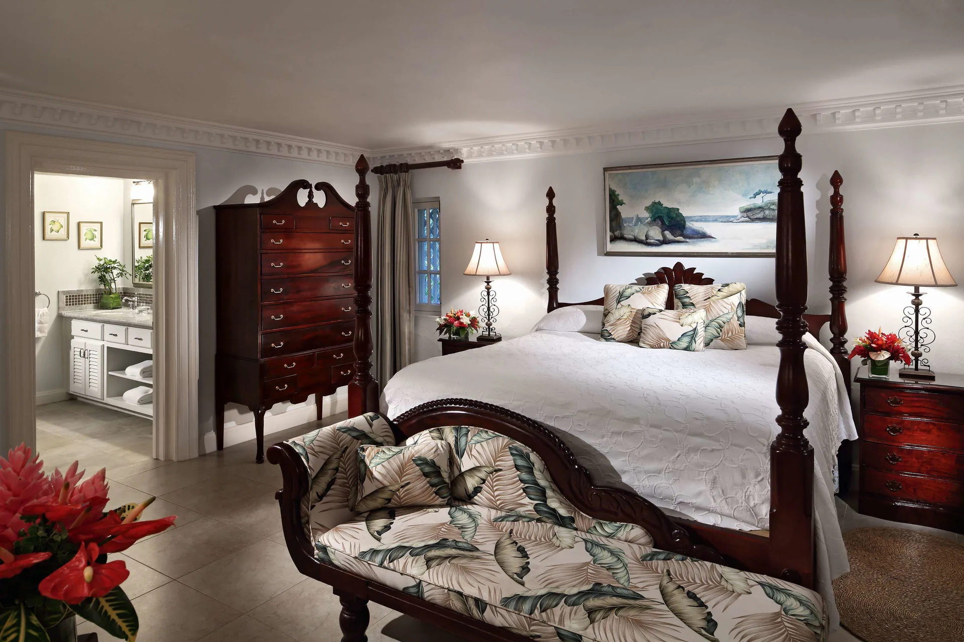 Ocean Suite bedroom with four-poster bed and bath doorway at Half Moon.