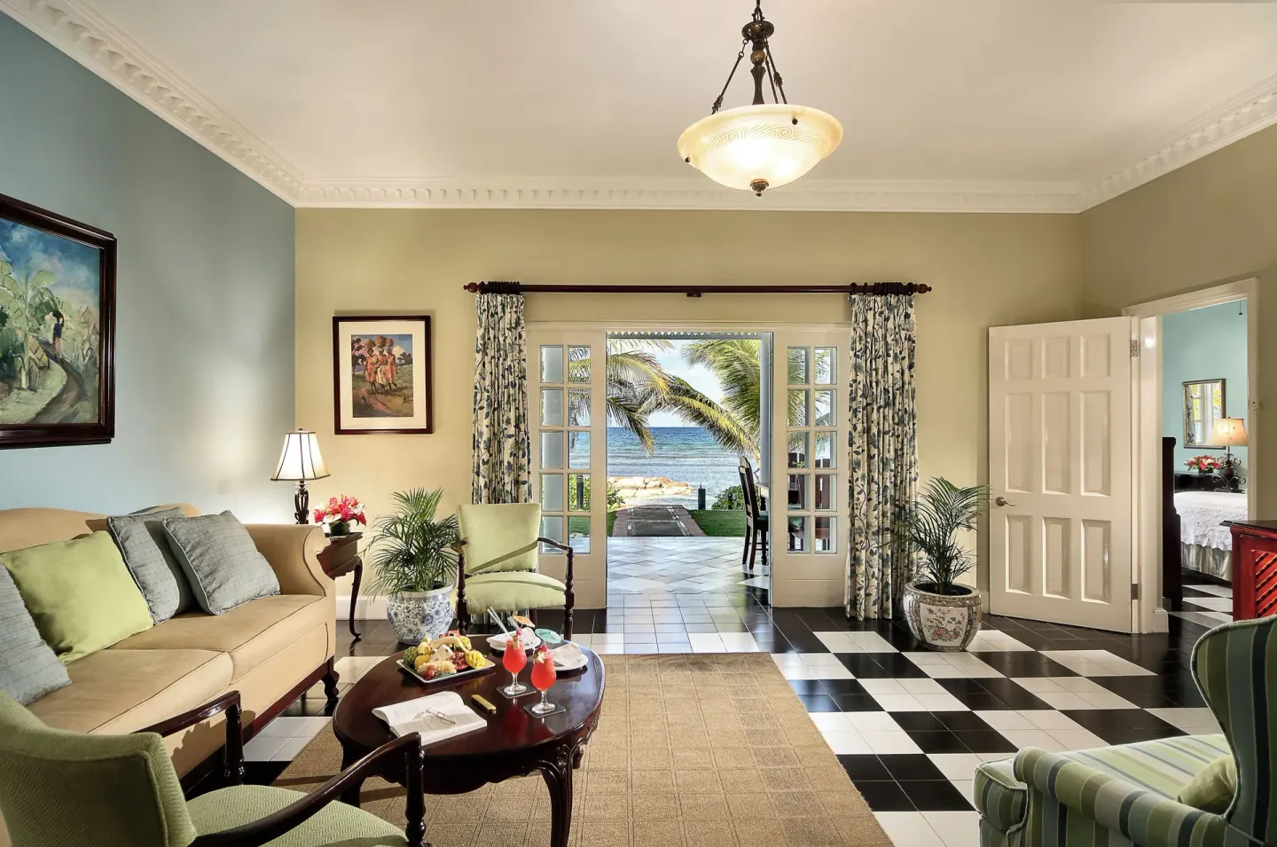 Ocean Suite living room with open doors to the sea at Half Moon.
