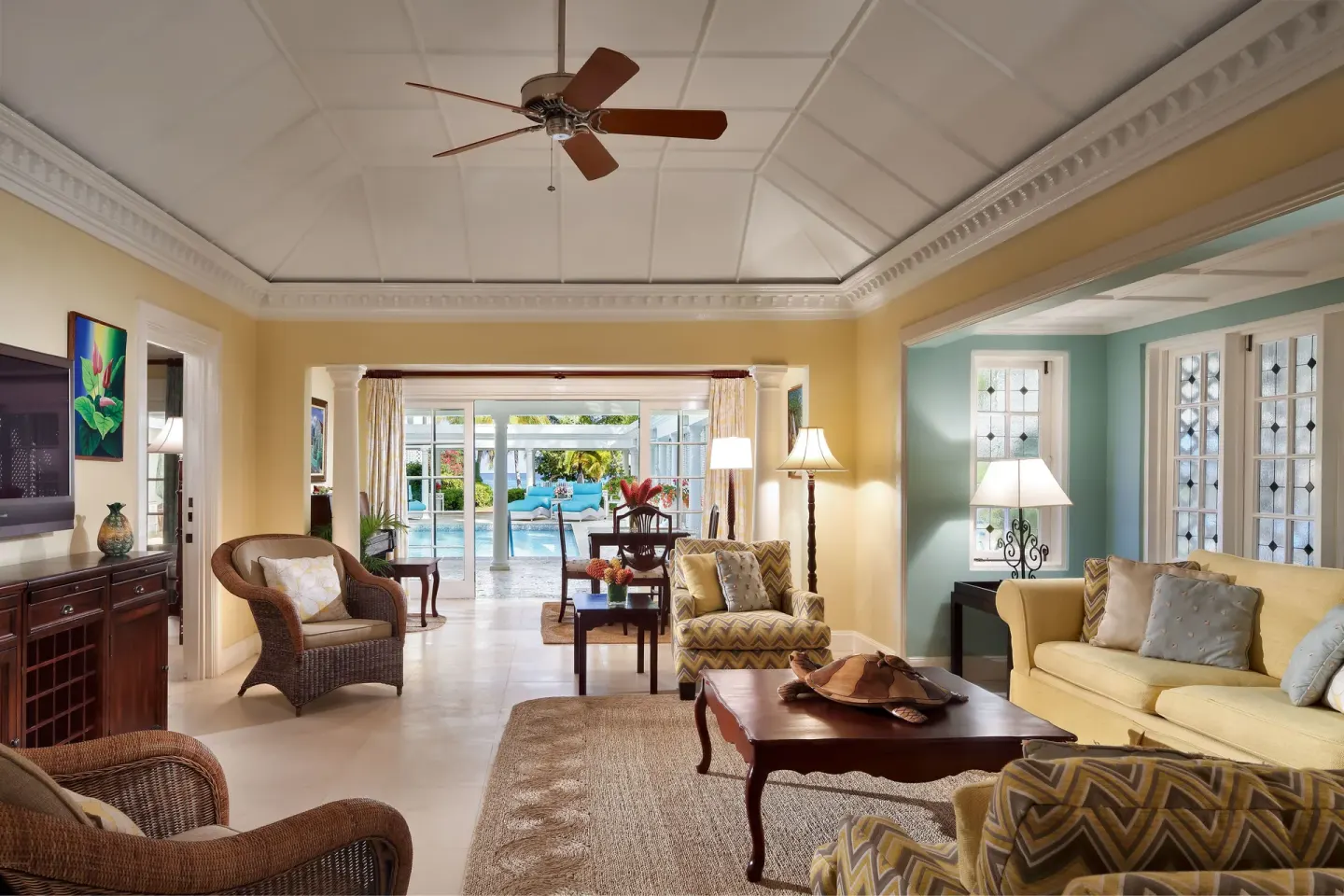 Suite living room with pool visible through glass doors at Half Moon.