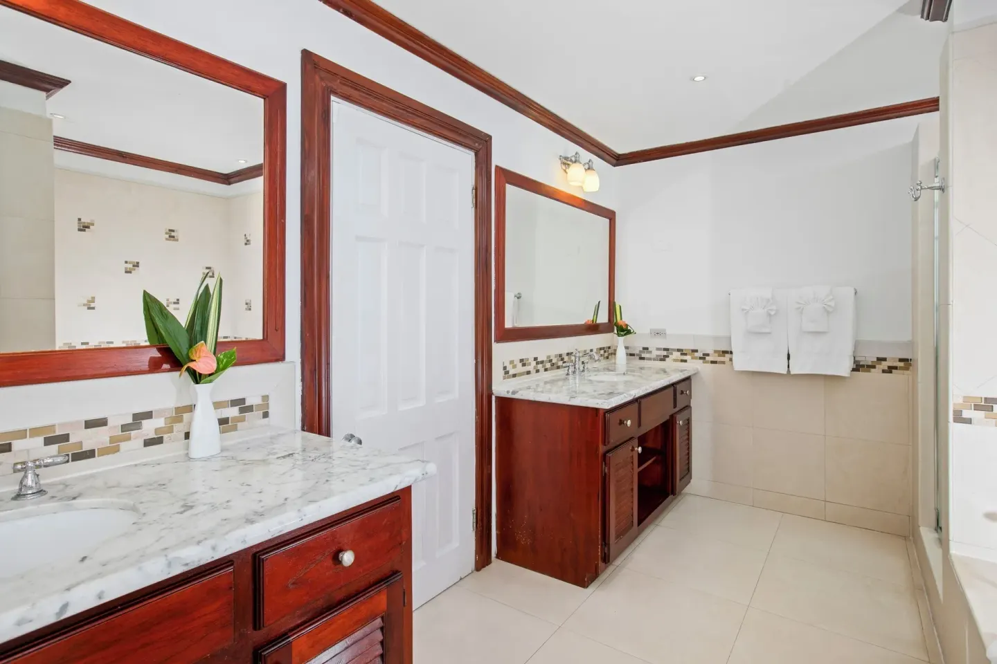 Ocean Prestige Suite bathroom with marble vanities and shower at Half Moon.