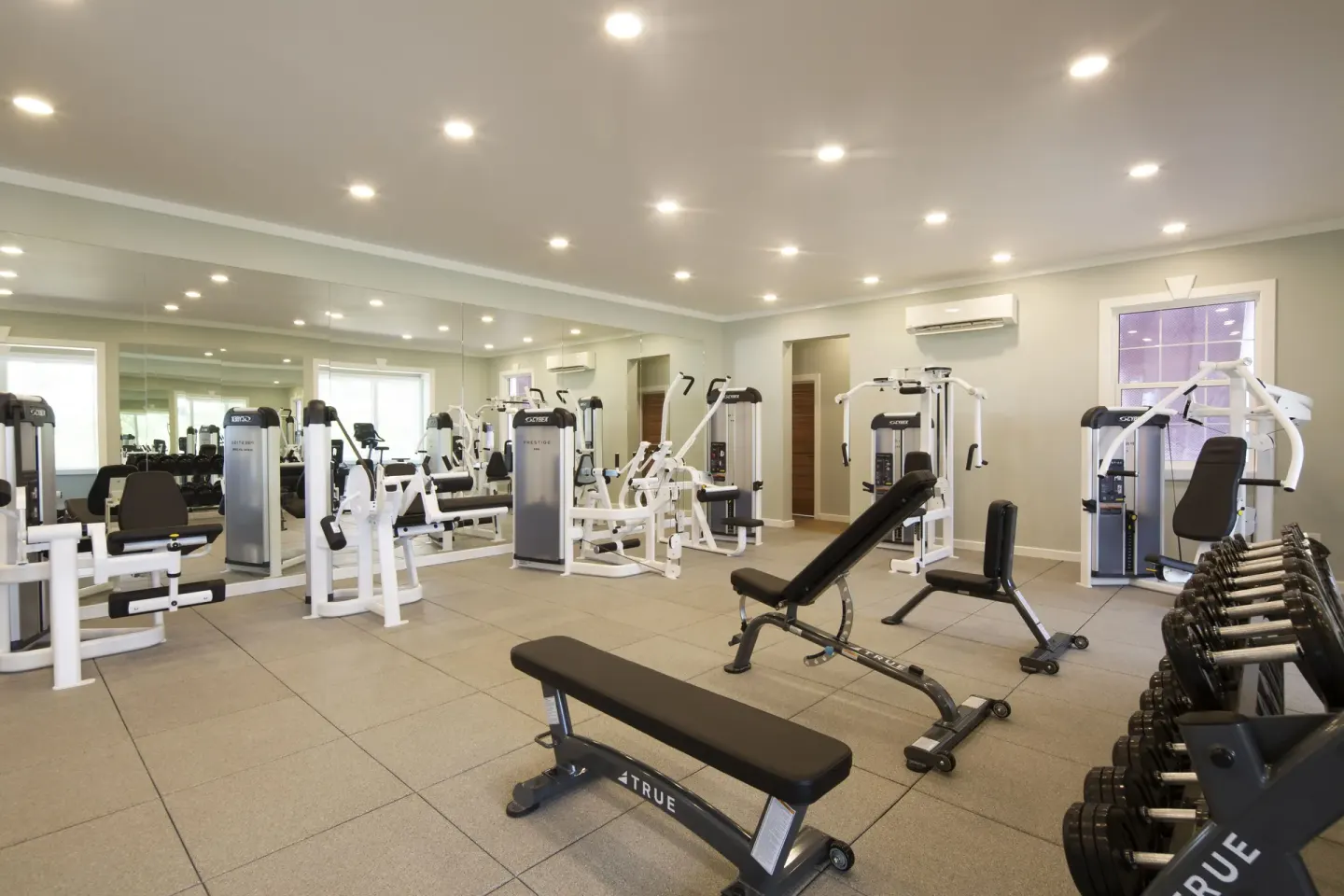Fitness room with weight machines, benches, and dumbbells at Hammock Cove Antigua.