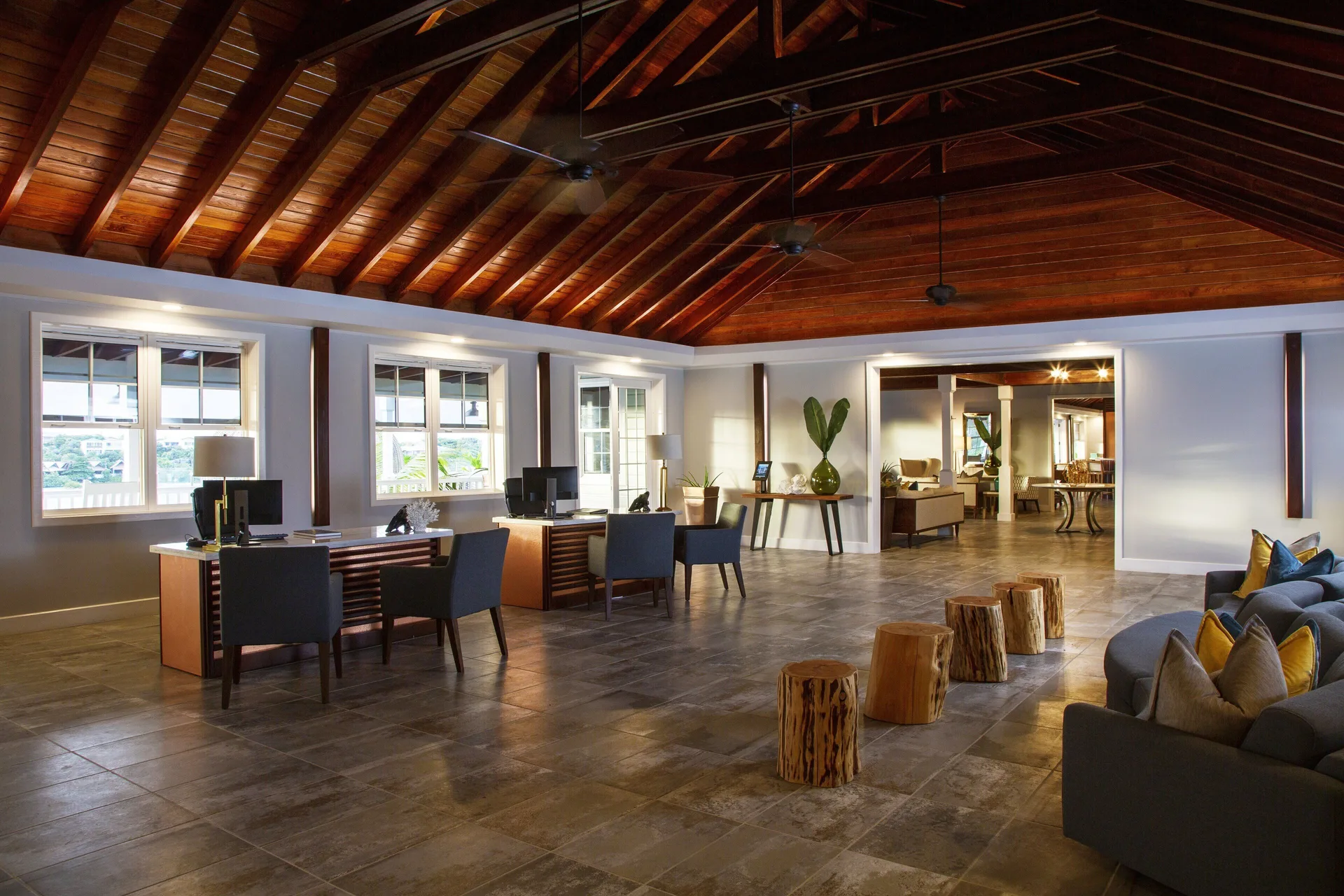 Lobby seating and reception desks beneath a wood ceiling at Hammock Cove Antigua.