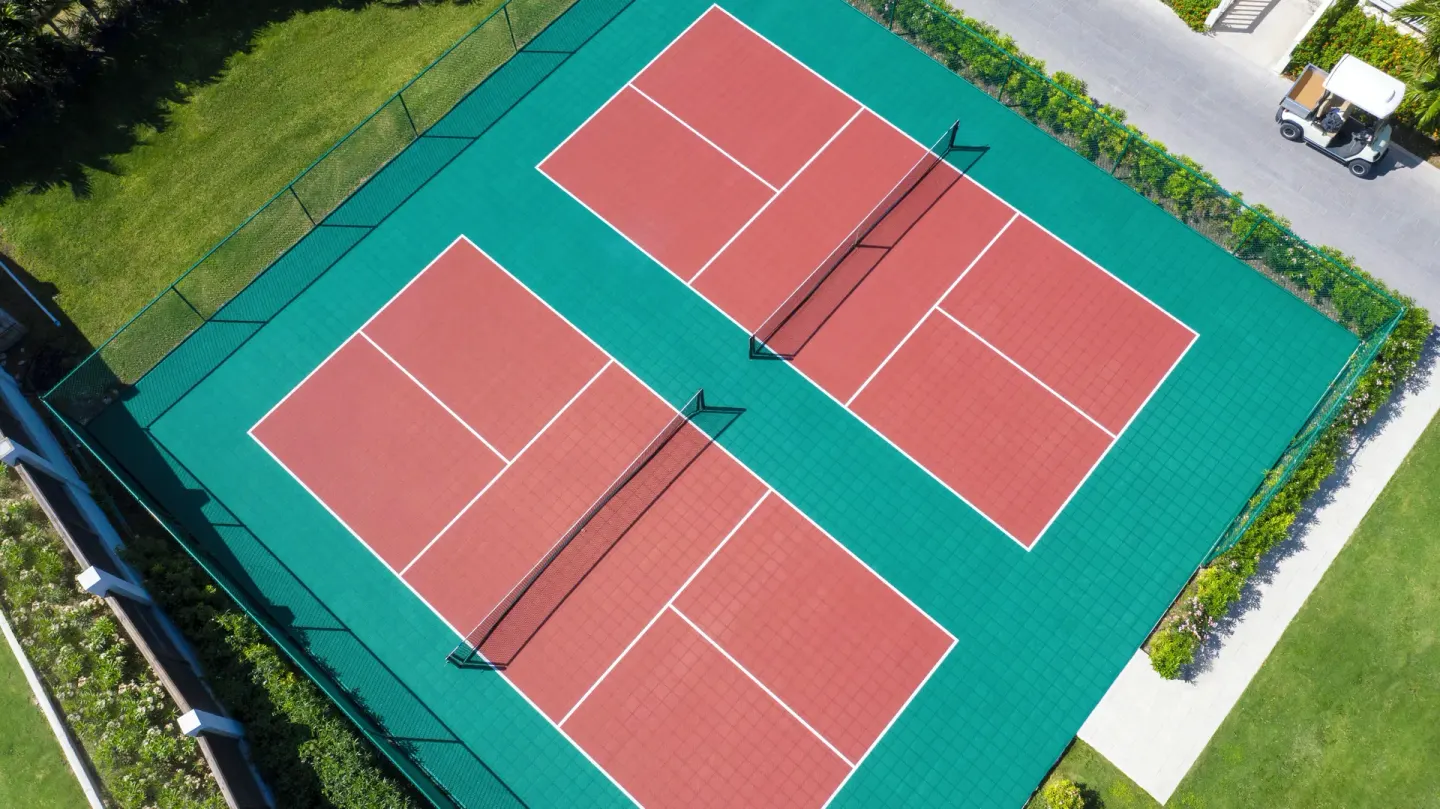Aerial view of two red and green pickleball courts at Hammock Cove Antigua.